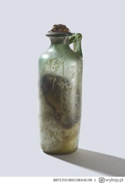 IMPERIUMROMANUM - Szklane naczynie z nienaruszonym korkiem i zawartością

Szklane nac...