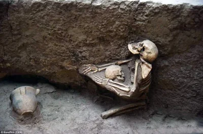 cheeseandonion - 4000-year-old skeletons of an adult woman trying to shield a child d...