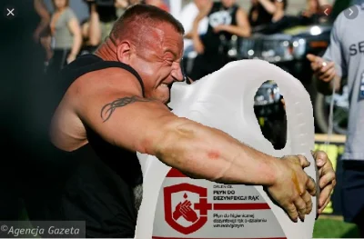 C.....a - Mariusz Pudzianowski pomaga rozładować paletę z płynem do dezynfekcji marki...