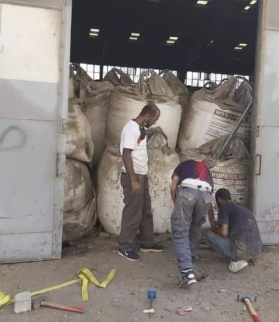 c.....i - > Unconfirmed picture appears to show workers welding door of warehouse fil...
