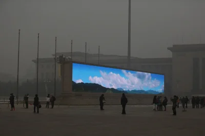 b.....r - Ekran LED pokazuje błękitne niebo na placu Tiananmen pośród gęstego smogu w...