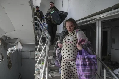 janek_ - >An injured pregnant woman walks downstairs in the damaged by shelling mater...