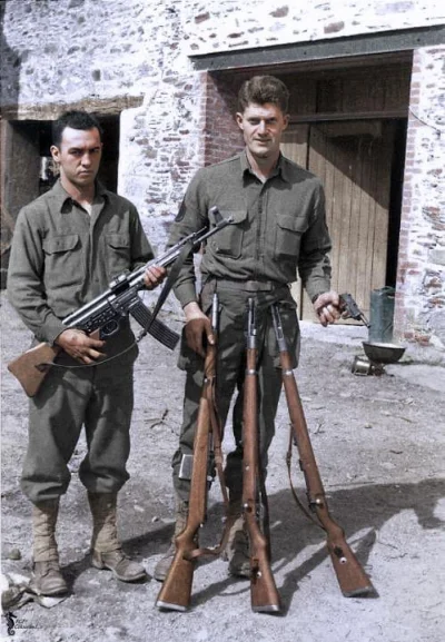 wojna - Dwóch żołnierzy amerykańskich prezentuje niemiecką broń zdobytą w Normandii. ...