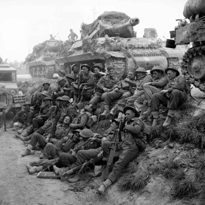 wfyokyga - "Eighth Army. Advance of Ferrara. British Infantrymen rest by the roadside...