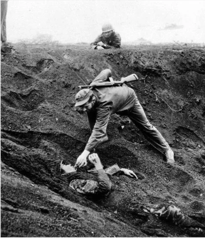 cheeseandonion - >A US Marine gives a cigarette to a Japanese soldier buried in the s...