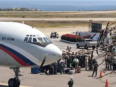 Sababukin - > Russian troops are seen disembarking from a transport plane outside Car...