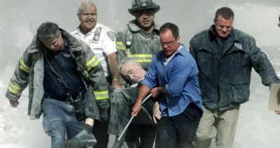 A.....1 - Zdjęcie przedstawia strażaków i pracowników innych służb niosących ciało ka...
