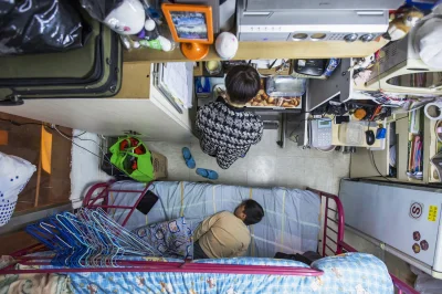 n.....n - > A woman and her son in their 60-square-foot sub-divided flat, with a mont...