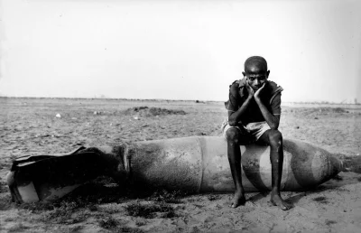 myrmekochoria - Mężczyzna siedzi na bombie niedaleko miasta Massawa podczas wojny o n...
