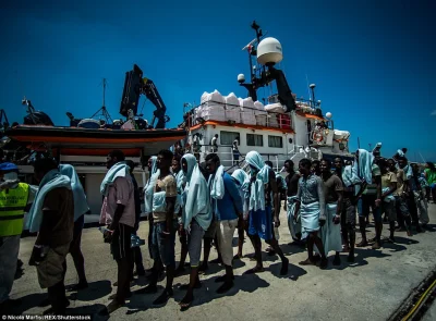 callya - > The group of men, women and children lined up after being rescued by the c...