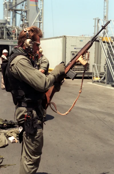 johann89 - > A member of Sea-Air-Land (SEAL) Team 8 checks his 7.62mm M-14 rifle aboa...