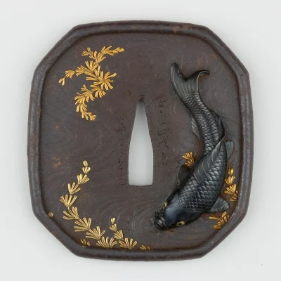 myrmekochoria - Tsuba z karpiem koi pływającym w stawie, Japonia 1615–1868.

Muzeum...