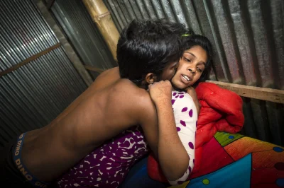 myrmekochoria - Pakhi, 15, with a customer in her room in the Kandapara brothel. She’...