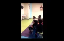 Urocze małe dziecko mówi do nauczyciela, podczas zakończenia przedszkola