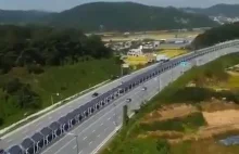 Ścieżka rowerowa w tunelu z paneli słonecznych biegnąca środkiem autostrady