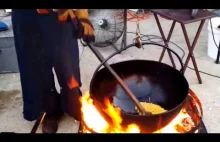 Amish man and wife making kettle cooked popcorn.
