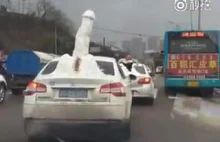 Car carries snow penis to parade on street