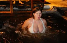 Russian tradition of bathing and swimming in the ice winter Christian...