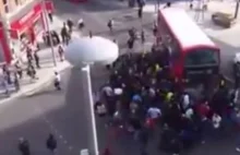 Watch this crowd of complete strangers lift a BUS to free a trapped...
