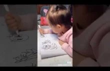 Azjatyckie dziecko rysuje koty...