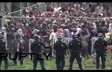 Riot police teargas refugees attempting to break out of detention camp i...