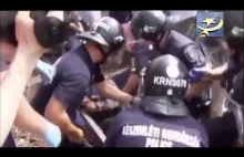 Imigranci na węgierskim dworcu - muzułmanin pozoruje atak policjantów na...