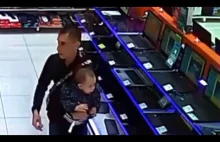 Father uses his TODDLER son to cover up stolen laptop under his trousers...
